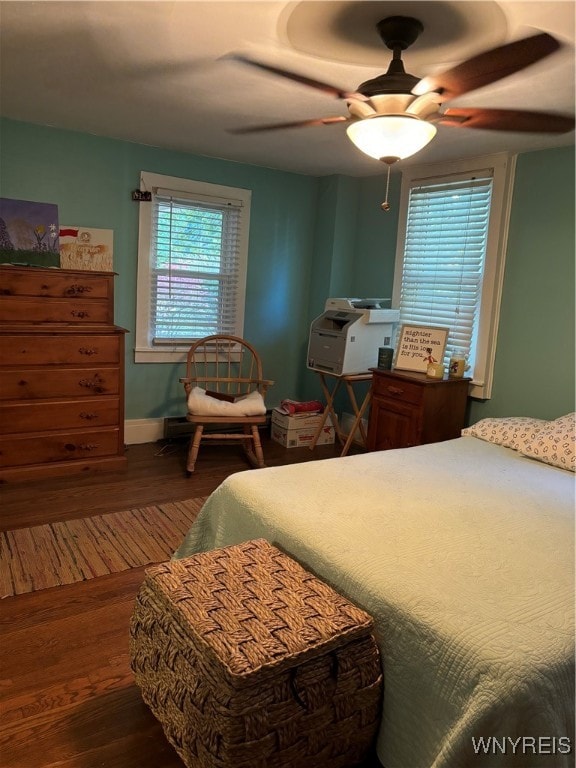 bedroom with ceiling fan and hardwood / wood-style flooring