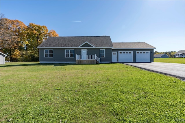 ranch-style home featuring a garage and a front lawn