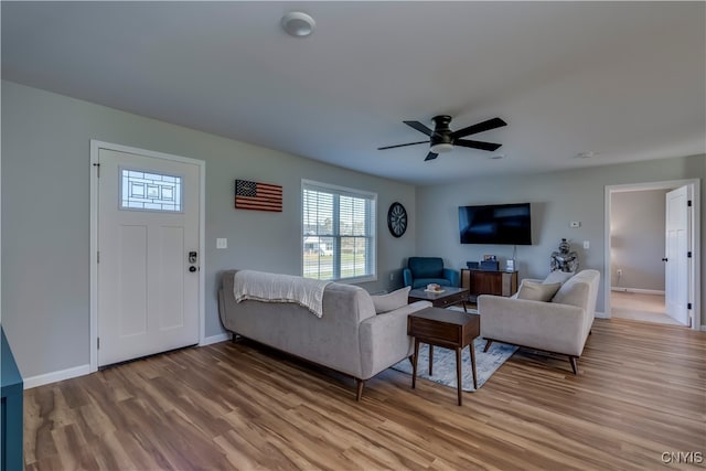 living room featuring ceiling fan and light wood-type flooring