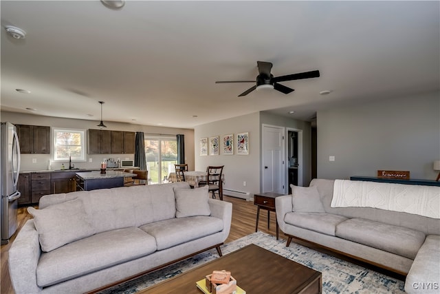 living room featuring light hardwood / wood-style floors and ceiling fan