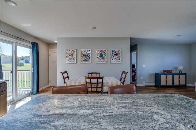 dining area with a baseboard radiator and hardwood / wood-style floors