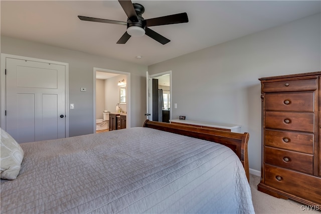 carpeted bedroom featuring ensuite bathroom and ceiling fan