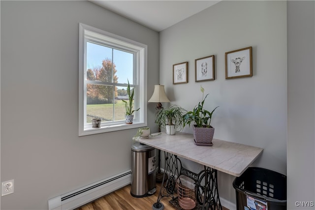 office space featuring a baseboard radiator and wood-type flooring