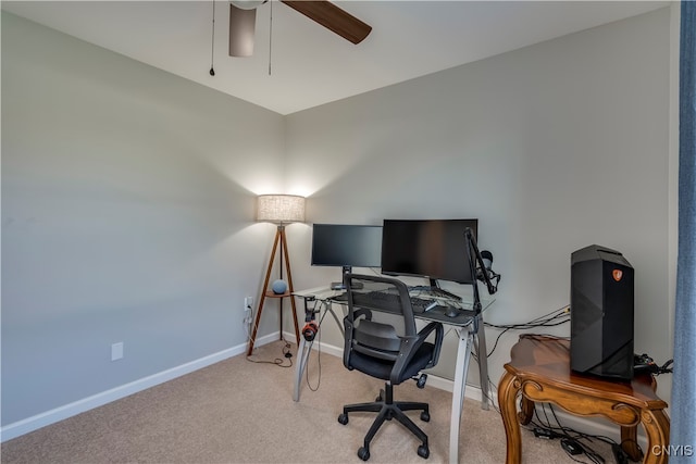 carpeted home office featuring ceiling fan