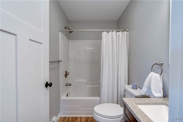 full bathroom featuring toilet, baseboard heating, vanity, hardwood / wood-style flooring, and shower / bathtub combination with curtain