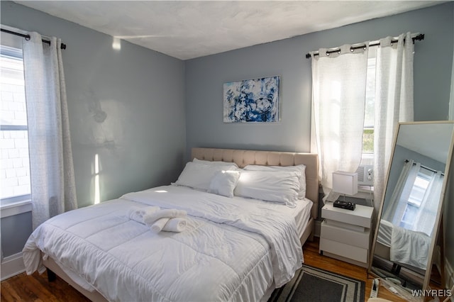 bedroom featuring multiple windows and hardwood / wood-style floors