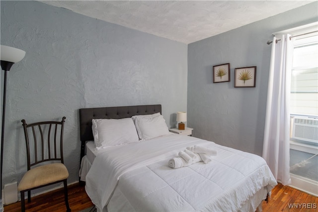 bedroom with a textured ceiling and hardwood / wood-style floors