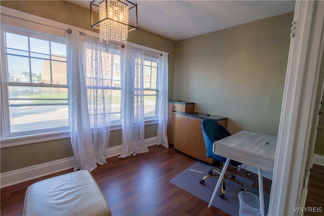 home office featuring a textured ceiling, a notable chandelier, and dark hardwood / wood-style floors