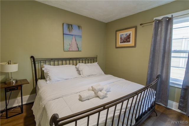 bedroom featuring dark hardwood / wood-style flooring