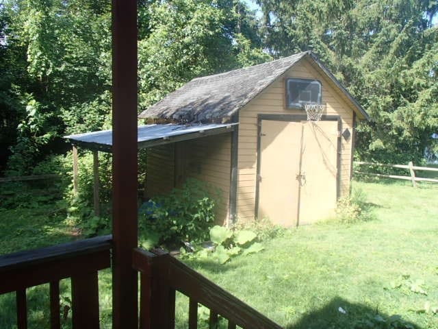 view of outdoor structure featuring a lawn