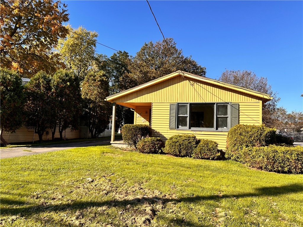 view of home's exterior with a yard