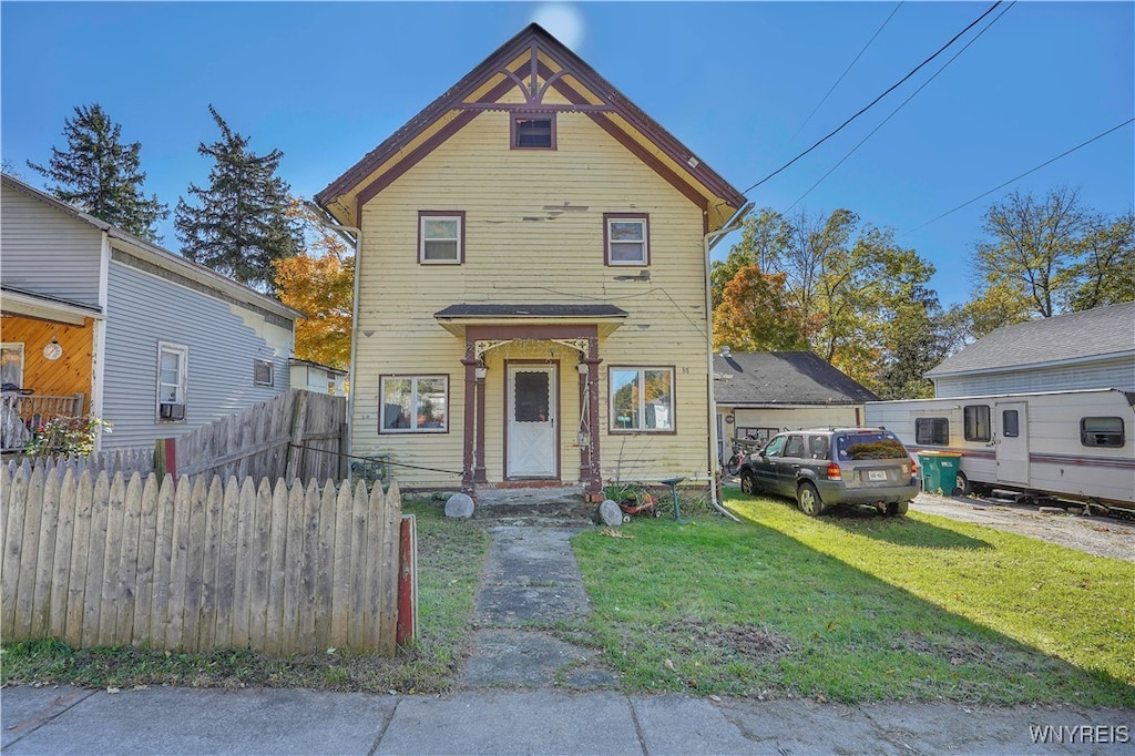 victorian home featuring a front lawn