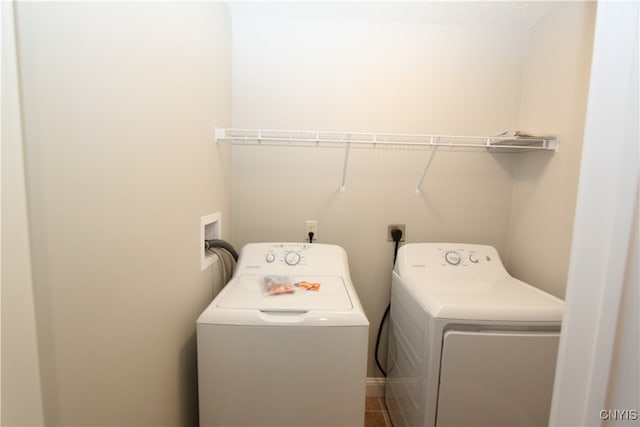 clothes washing area featuring washer and dryer