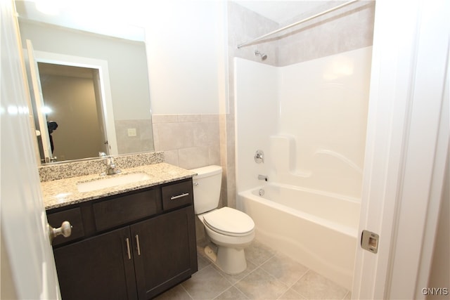 full bathroom featuring shower / washtub combination, tile walls, toilet, vanity, and tile patterned flooring