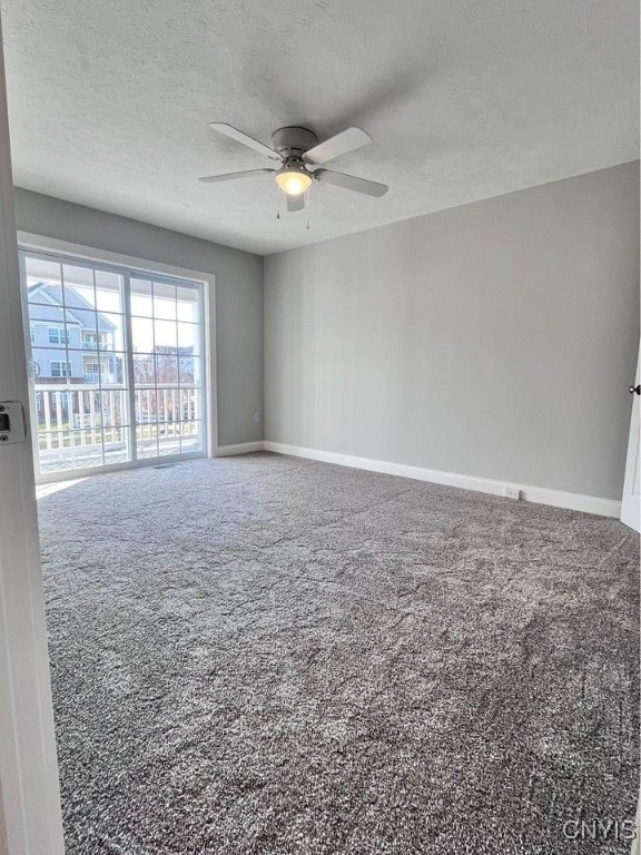 unfurnished room featuring carpet floors, a textured ceiling, and ceiling fan