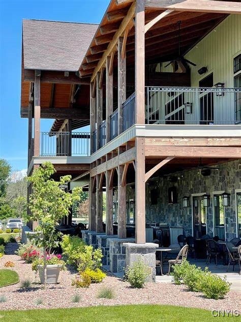 back of property with a patio area and a balcony