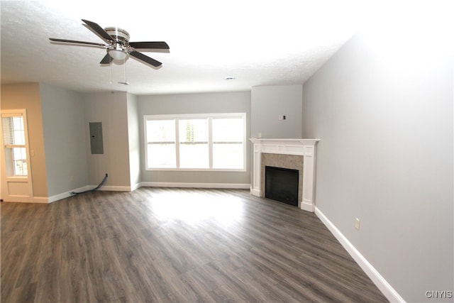 unfurnished living room with dark wood-type flooring, ceiling fan, and a healthy amount of sunlight