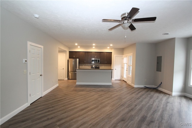 unfurnished living room with ceiling fan, electric panel, a textured ceiling, and dark hardwood / wood-style flooring