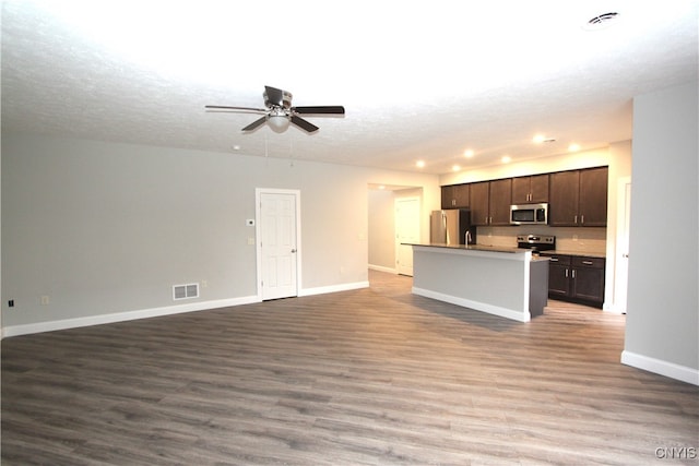 interior space with a textured ceiling, wood-type flooring, and ceiling fan