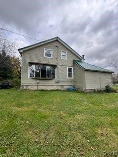 rear view of house with a lawn