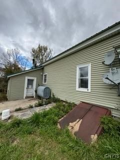 view of side of home with heating fuel