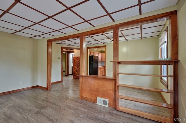 unfurnished room with hardwood / wood-style floors