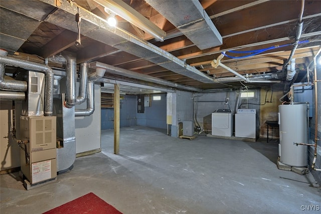 basement with water heater, heating unit, and washing machine and clothes dryer