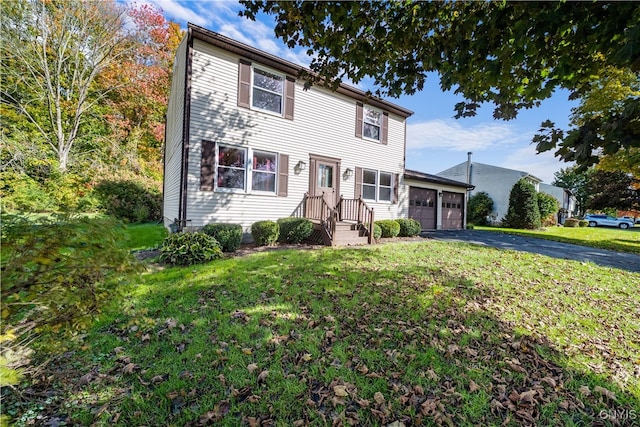 view of front of home featuring a front lawn and a garage