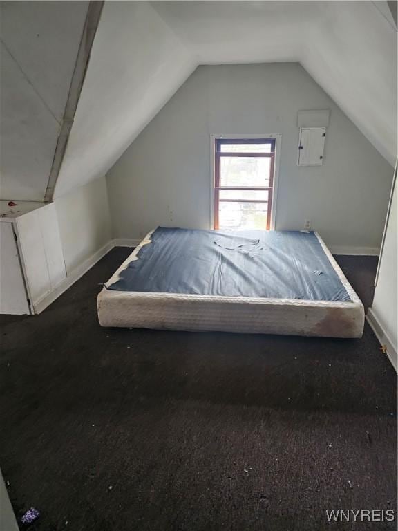 carpeted bedroom featuring vaulted ceiling and baseboards