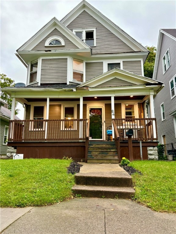 view of front of house featuring a porch and a front lawn