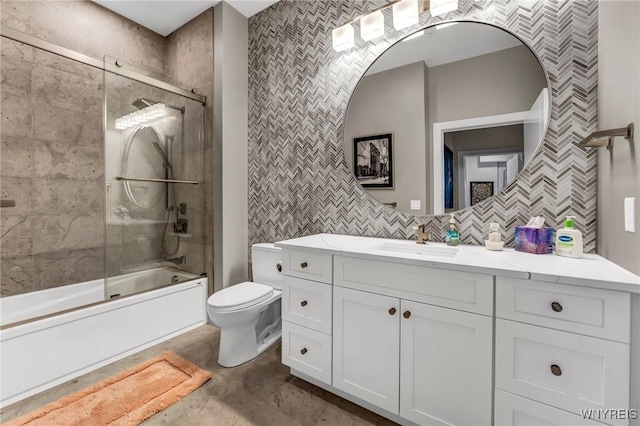 full bathroom with tasteful backsplash, vanity, combined bath / shower with glass door, and toilet