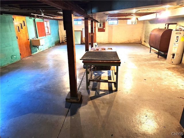 basement featuring water heater and sink