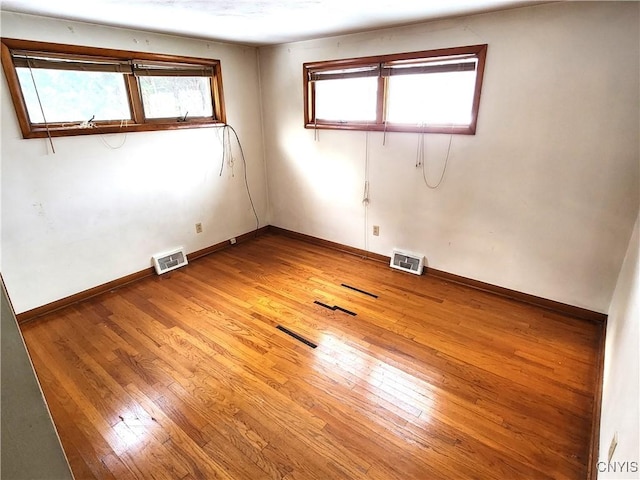 empty room with hardwood / wood-style floors