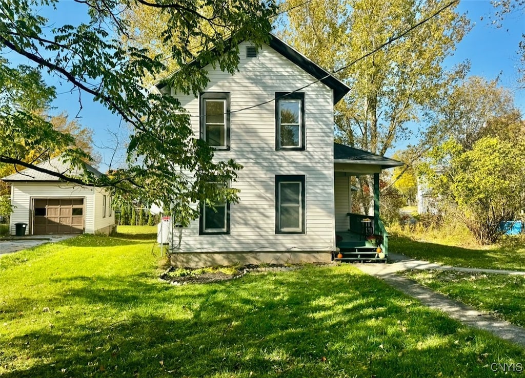 view of home's exterior with an outdoor structure, a yard, and a garage