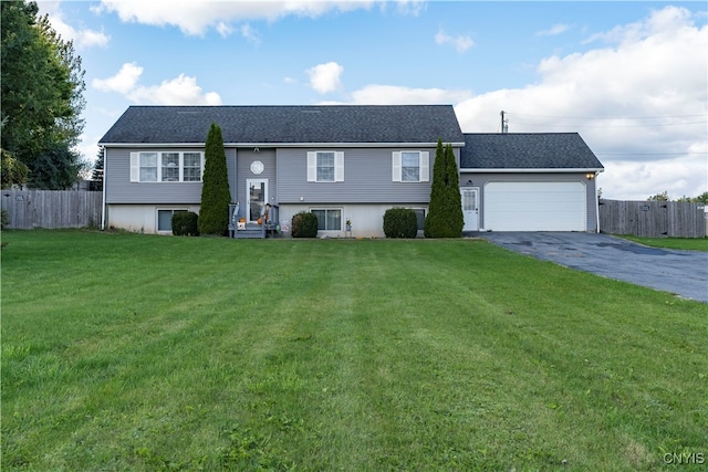 split foyer home featuring a front yard and a garage