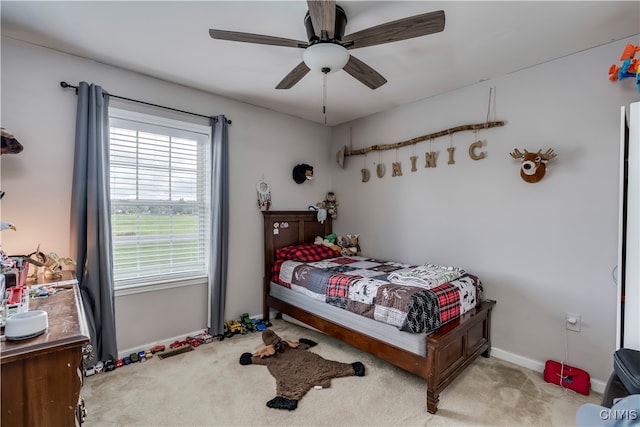 bedroom with light colored carpet and ceiling fan