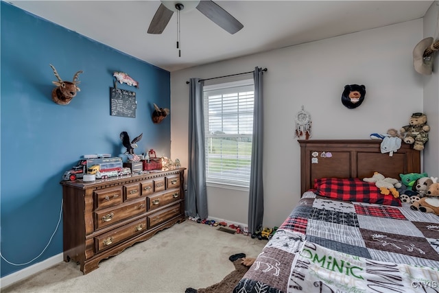 bedroom featuring ceiling fan and light carpet