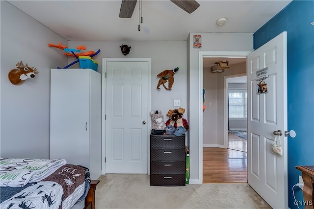 bedroom featuring ceiling fan and light colored carpet