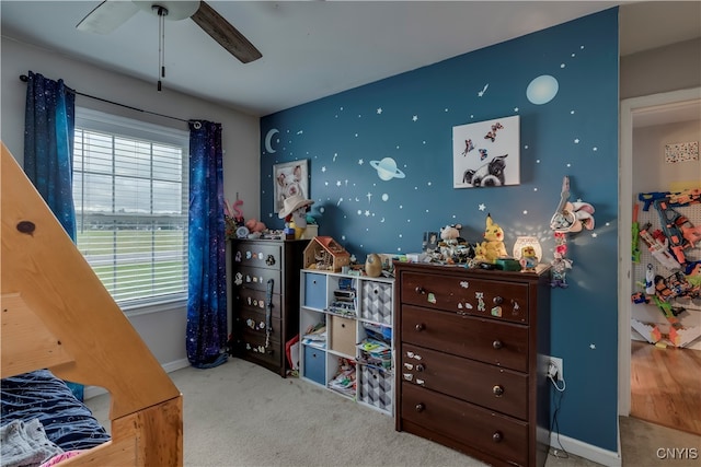 bedroom featuring ceiling fan and light carpet