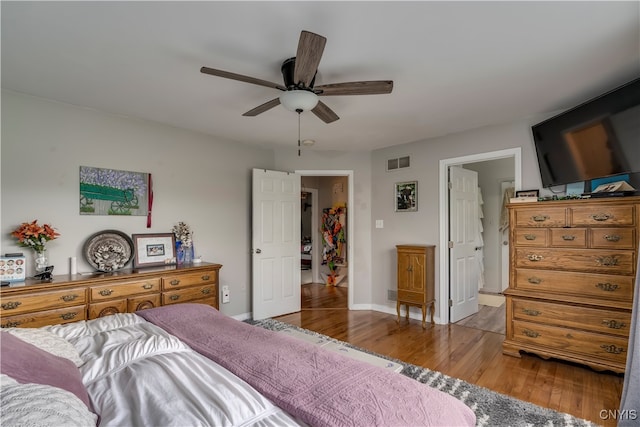 bedroom with light hardwood / wood-style floors and ceiling fan