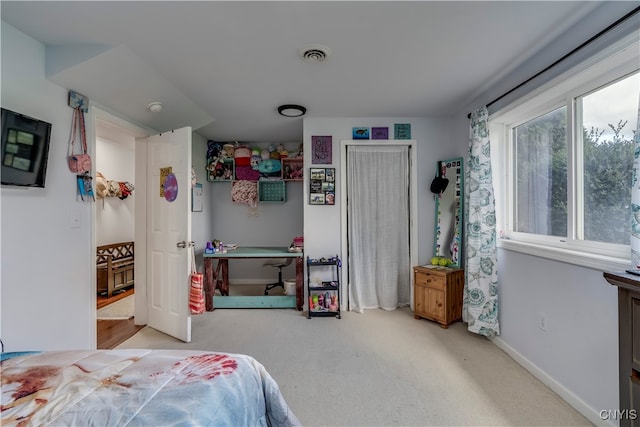 bedroom featuring light carpet