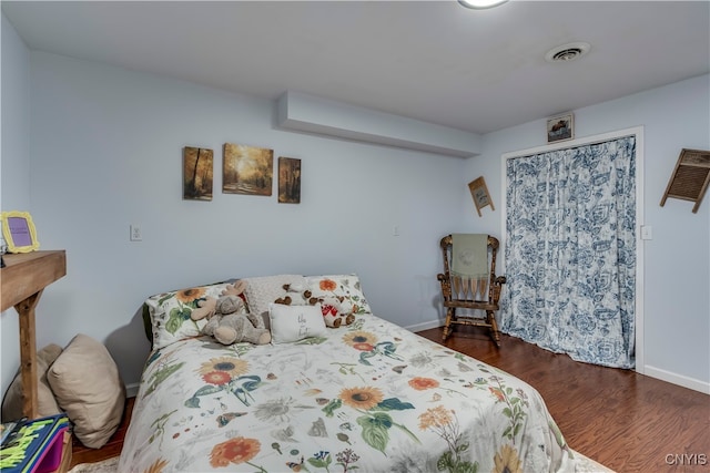 bedroom featuring dark hardwood / wood-style flooring