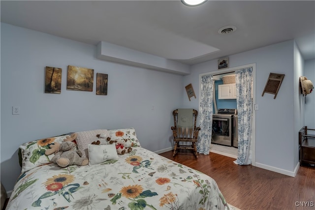 bedroom with dark hardwood / wood-style floors