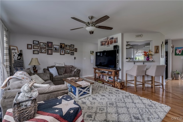 living room featuring ceiling fan and hardwood / wood-style flooring