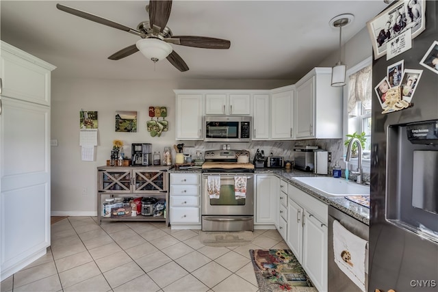 kitchen with sink, decorative backsplash, appliances with stainless steel finishes, and white cabinets