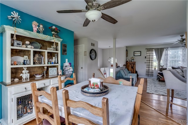 dining space with light wood-type flooring and ceiling fan