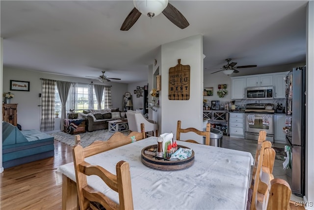 dining area featuring light hardwood / wood-style flooring and ceiling fan