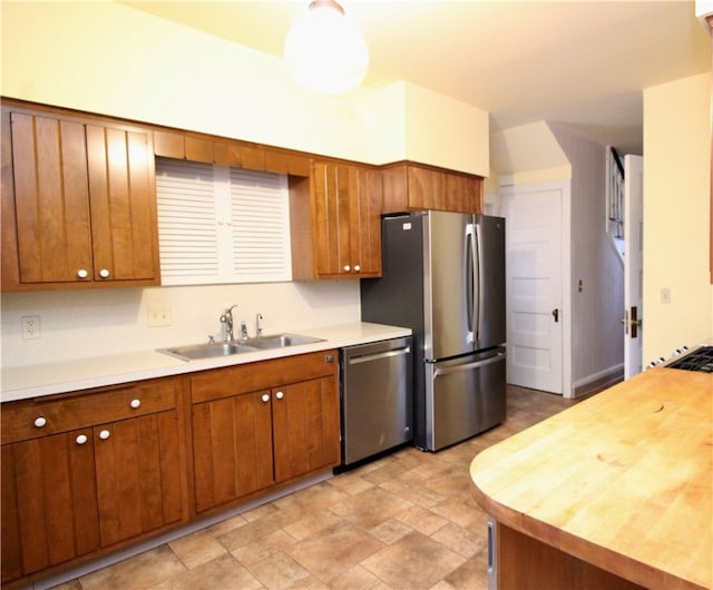 kitchen featuring sink, butcher block countertops, and stainless steel appliances