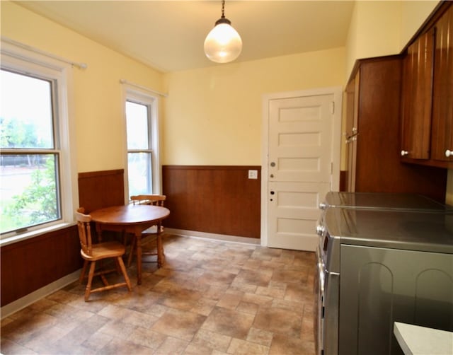 dining room with wooden walls and washing machine and dryer