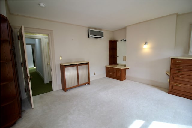 unfurnished bedroom featuring light carpet and a wall mounted AC